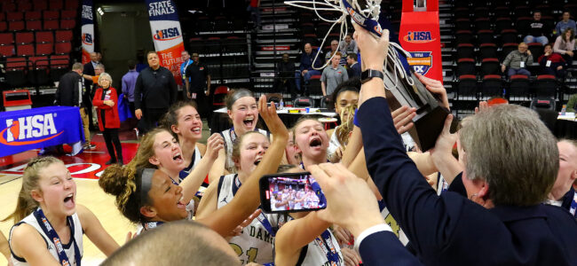 March 5, 2022 - Normal, Illinois - Members of the Quincy Notre Dame girls basketball team rush forward to receive their state basketball trophy at the Illinois High School Association Girls Basketball State Finals on Saturday. The Lady Raiders defeated the Indians 63-56 to take home this year's Class 2A state trophy. (Photo: PhotoNews Media/Clark Brooks)