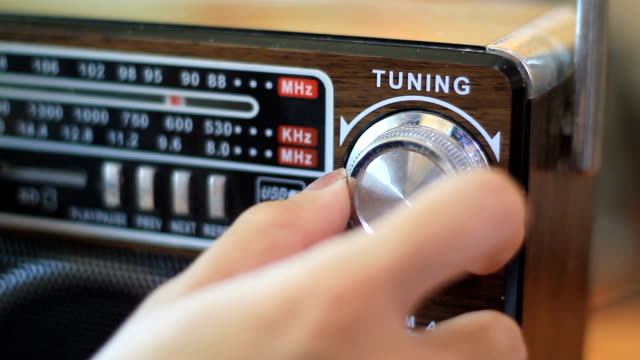 Tuning FM radio stations on receiver dial close-up- Radio station tune with dial on stereo FM