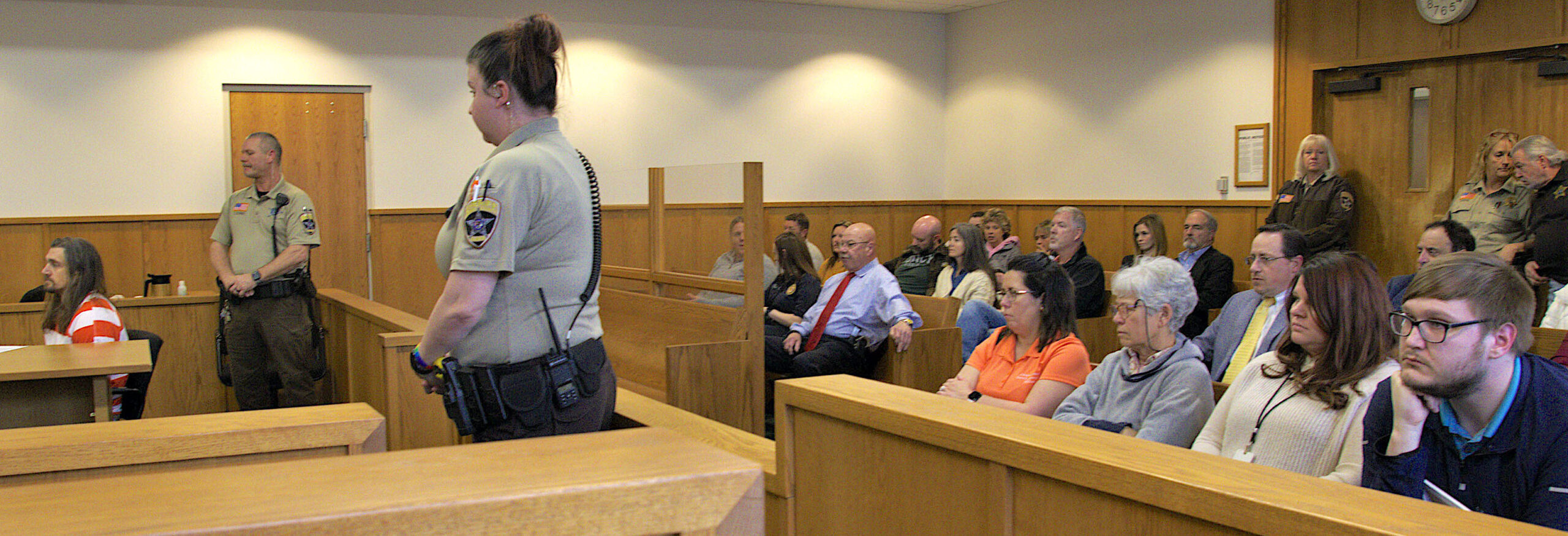 Members of the public, law enforcement, and family members wait for the judge to being the arraignment hearing Friday for Timothy Bliefnick.