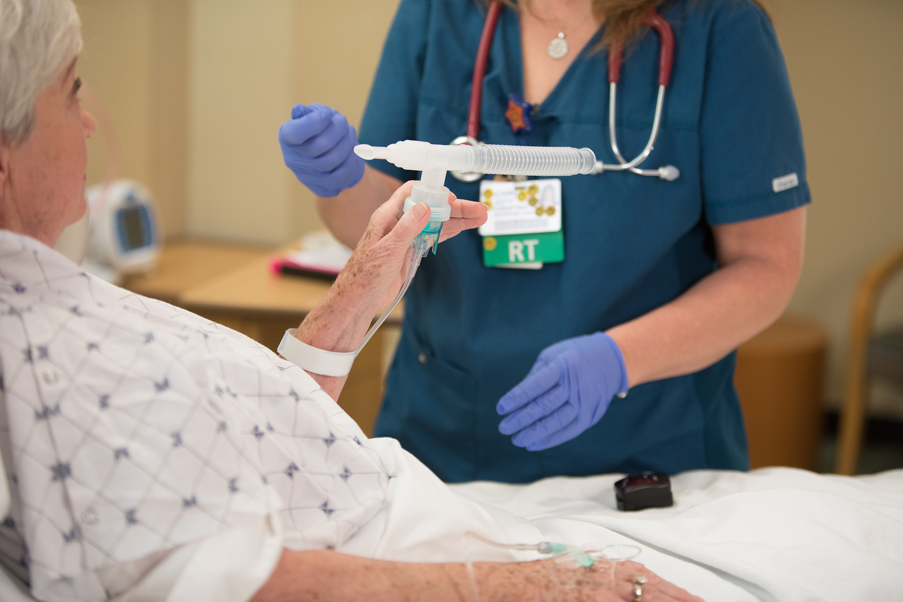 Respiratory therapist working with patient after having trouble