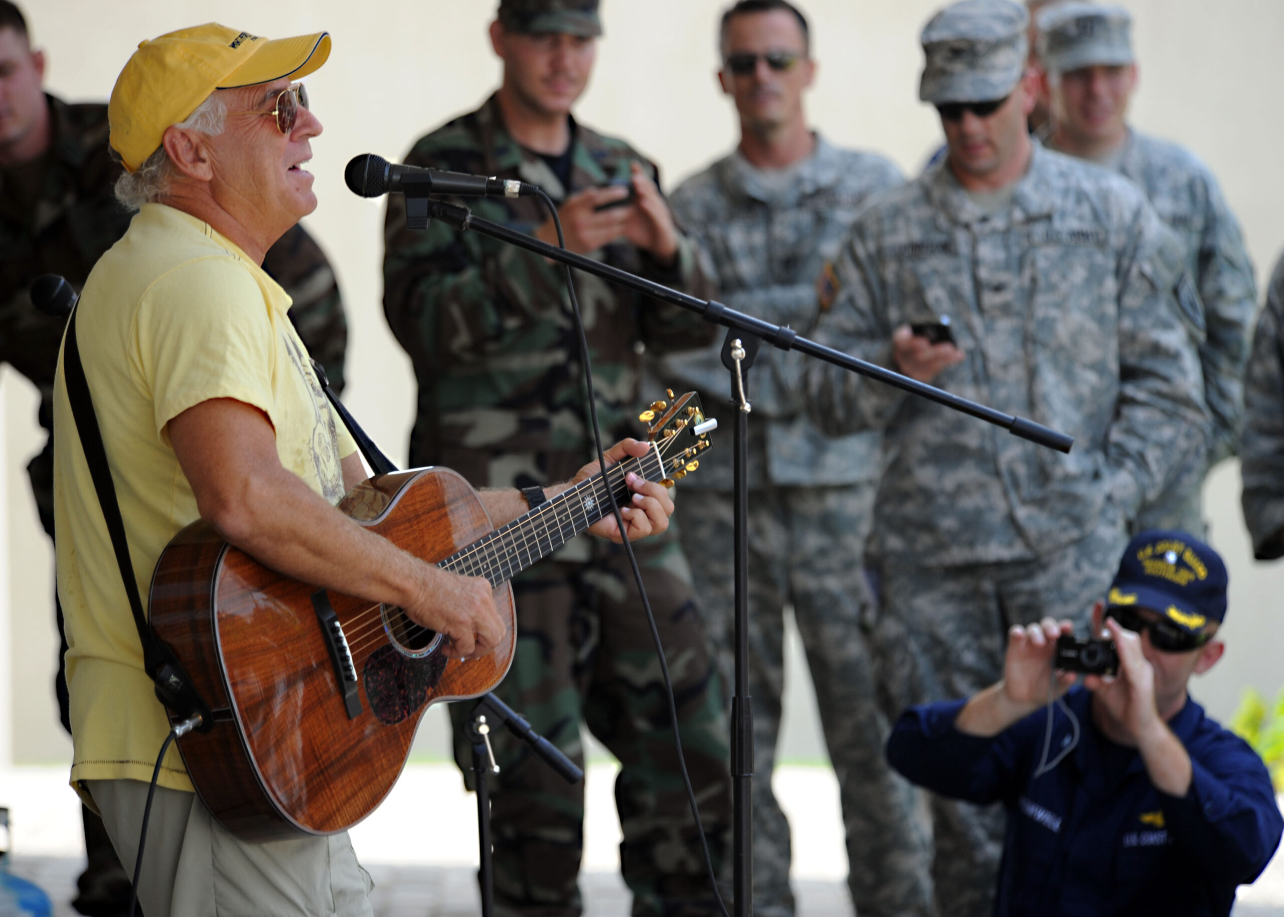 Musician Jimmy Buffet performs for members of Joint Task Force Haiti behind the U.S. Embassy in Port-au-Prince, Haiti, March 3, 2010. (U.S. Navy photo by Senior Chief Mass Communication Specialist Spike Call/Released)