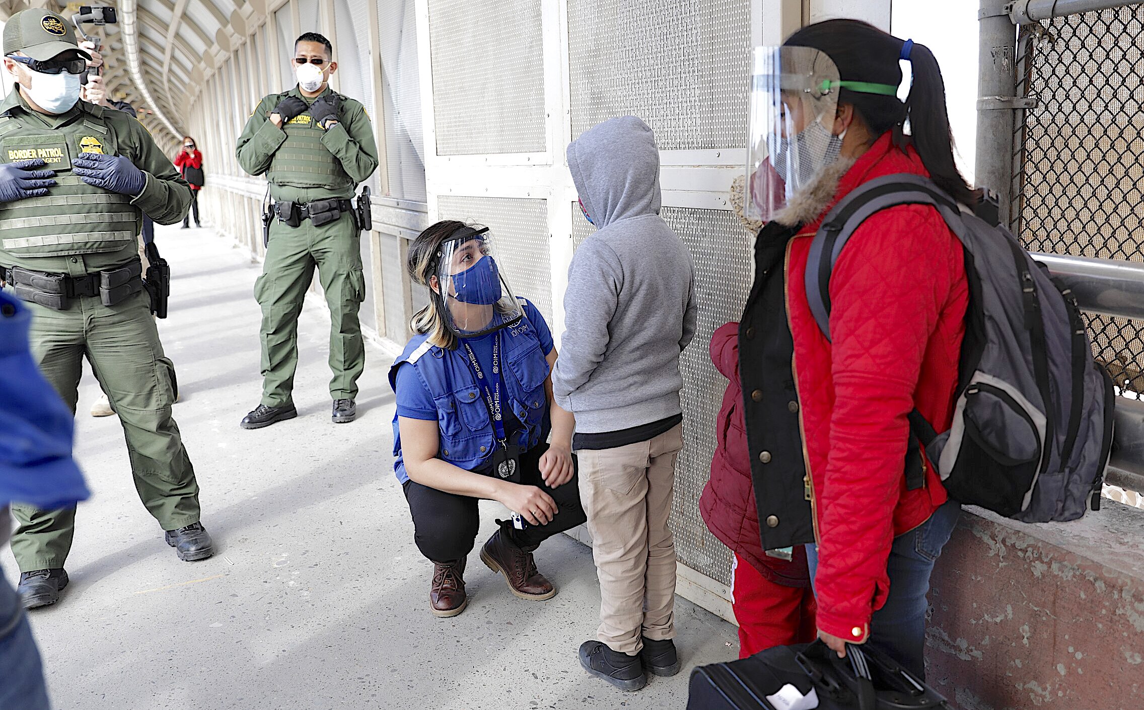 U.S. Customs and Border Protection officers and agents process a small group of asylum-seekers who have active applications under the Migrant Protection Protocols at the Paso del Norte Port of Entry in El Paso, Texas, February 26, 2021. Under the Migrant Protection Protocols established in January, 2019, migrants seeking asylum were required to remain in Mexico while their applications were processed. Migrants with the arriving group have tested negative for Covid-19 prior to making the crossing as DHS has begun the first step in a phased restoration of safe and orderly processing at the Southwest Border. CBP photo by Glenn Fawcett