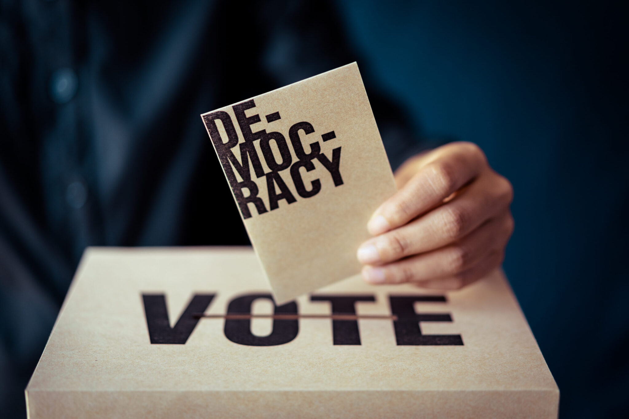 brown paper insert in vote box, democracy concept, retro tone