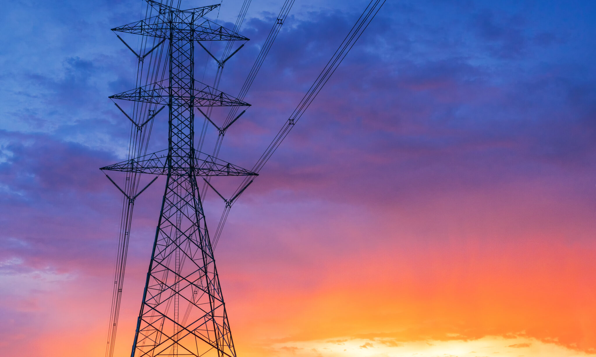 Electrical transmission power line, beautiful sunset sky on background