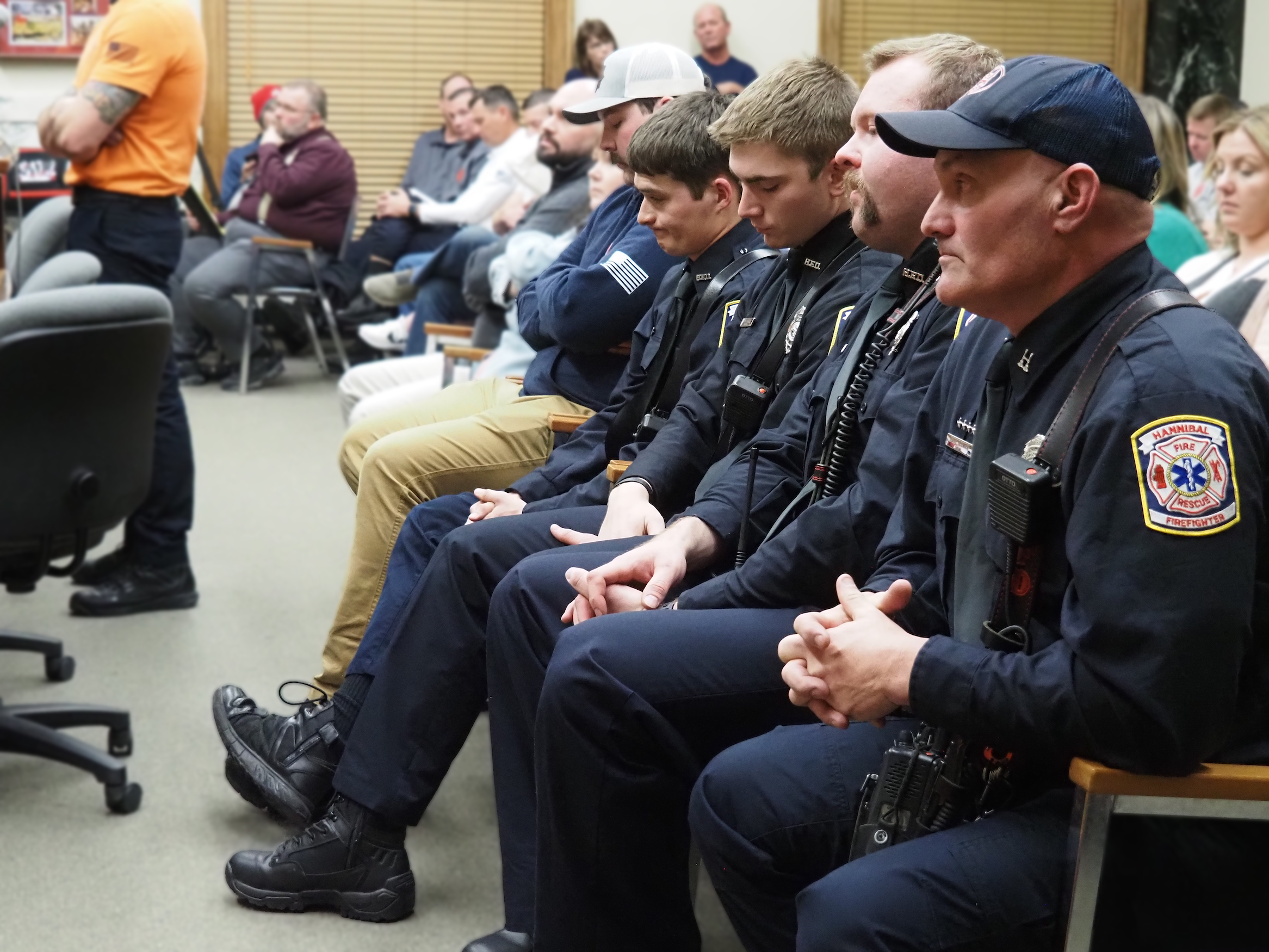 Members of the Hannibal Fire Department listen to International Association of Fire Fighters Local 1211 President Steven Meyer speak to the Hannibal City Council at last week's meeting. | Aspen Gengenbacher